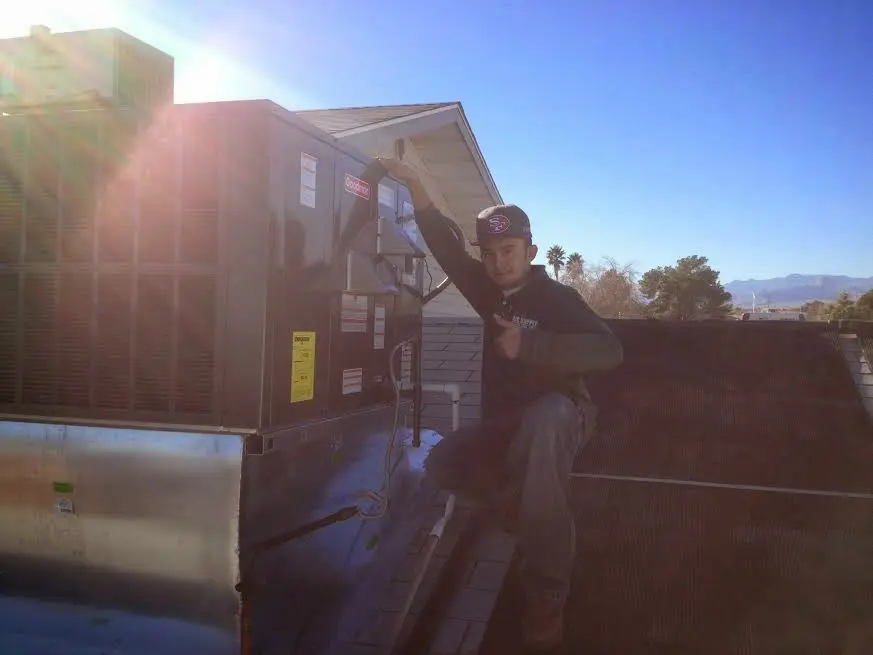 HVAC technician performing Boiler Repair on a rooftop unit in Argyle